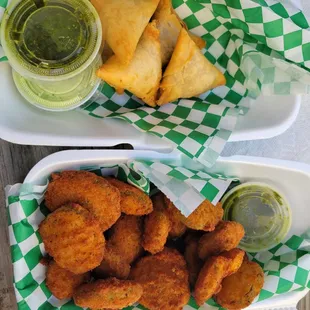 two trays of fried food with dipping sauce