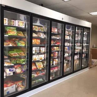 a row of refrigerators filled with food