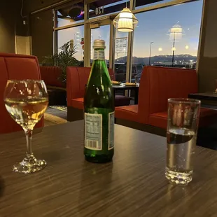 a bottle of wine and a glass of wine on a table