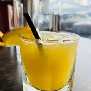 a glass of orange juice on a table