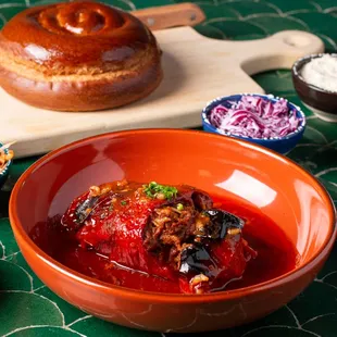 a bowl of tomato soup and a loaf of bread