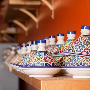 a shelf of colorful pottery