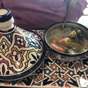 Tagine presentation of soup and couscous inside