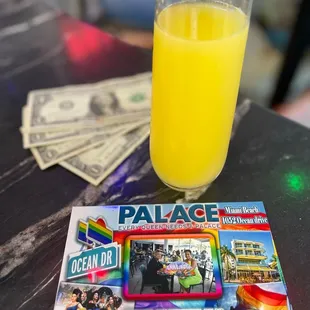 a glass of orange juice on a table