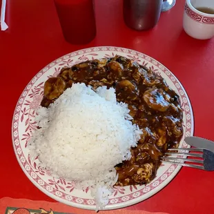 a plate of rice with a side of mushrooms