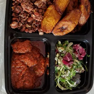 Purple rice and beans, fried plantains, goat stew and salad