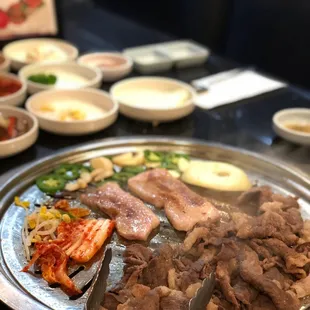 Beef brisket &amp; Pork Belly doing its thing along with some kimchi, beansprouts, jalepeno, garlic, and onion.