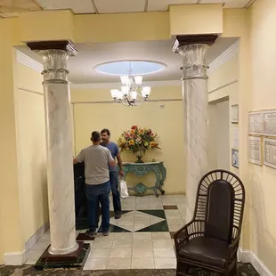 two men standing in a lobby