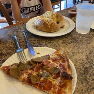 a slice of pizza on a paper plate