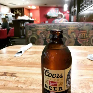 a bottle of beer sitting on a table