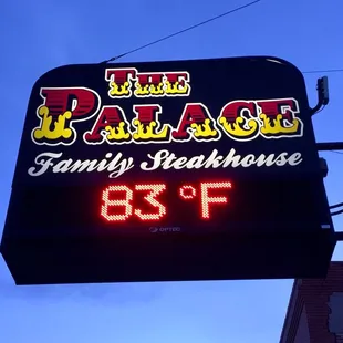 a neon sign for the palace family steakhouse