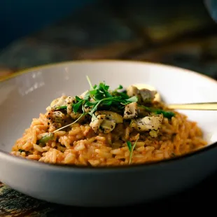 a bowl of risoped rice and a glass of wine