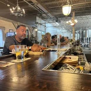 a man and a woman sitting at a bar
