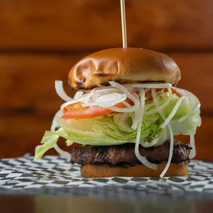 a hamburger with lettuce and tomato