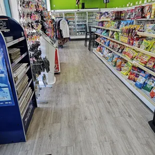 Mailing boxes, souvenirs, shirts, and table &amp; chairs at the end of the snack shelves