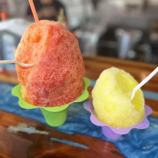 ows two ice cream cones with strawberries on them