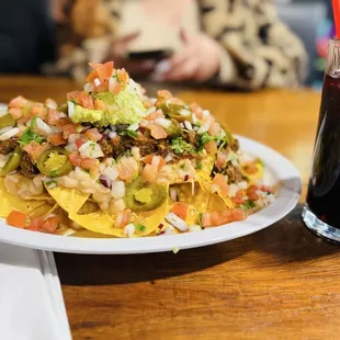 Birria Nachos with agua Fresca de Jamaica.