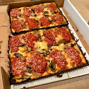 four slices of pizza in a box