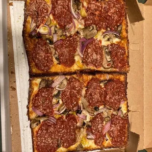 four slices of pizza in a box