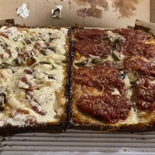 Chicken carbonara pizza and sausage red onion and mushroom pizza.