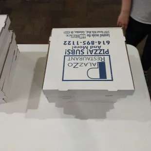 pizza boxes stacked on a table