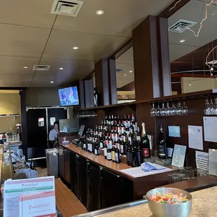 a bar with a bowl of fruit on the counter