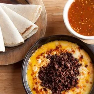 Choriqueso
 Sizzling skillet filled with Melted Muenster cheese and real Mexican style Chorizo, simply delicious.