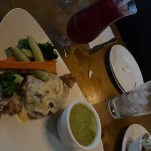 Shrimp stuffed tilapia with cream sauce on the side