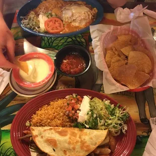 Chilqquiles and shrimp + steak quesadilla, plus chips and salsa with cheese dip as well!