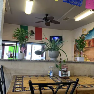 a dining area with a table and chairs