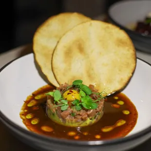 TUNA TARTAR 

Sushi grade tuna, Quail egg, pomegranate molasses ponzu, avocado mousse, baked corn tortillas
