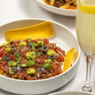 a plate of food and a glass of champagne