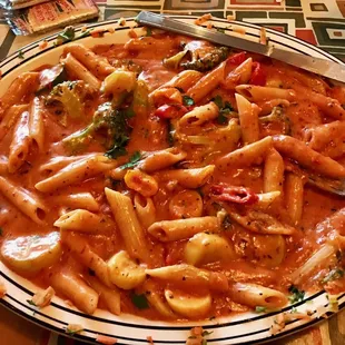 a plate of pasta and a glass of water