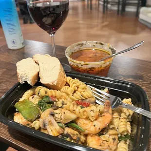 a plate of pasta and a glass of wine