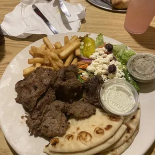 Souvlaki platter with fries and Greek salad.