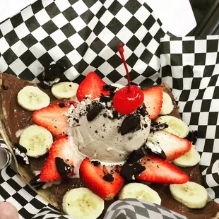 a slice of chocolate cake topped with strawberries and a cherry