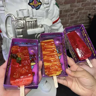 Strawberry Watermelon with chamoy and gummy bears, Mango Guanabana paleta with chamoy and Jamaica paleta