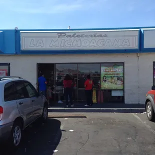 Front of store with line backing up outside