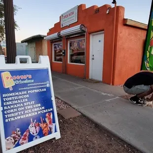 a man squatting on the sidewalk