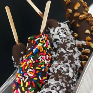 chocolate covered ice cream pops with sprinkles and nuts