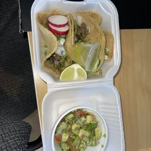 2 carne asada (steak) and 1 Al pastor (pork) tacos, fresh Chips with Guacamole