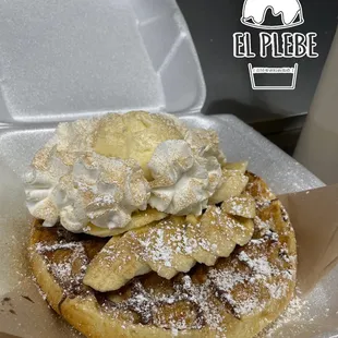 Fresh warm cinnamon waffle with Nutella, banana, and vanilla ice cream