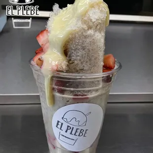 Homemade Vanilla raspado with fresh strawberries and lechera