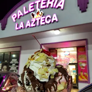 a hand holding a sundae