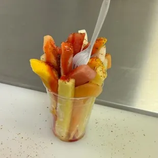 a fruit salad in a plastic cup