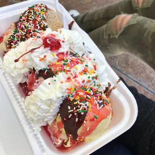 a banana split in a styrofoam container