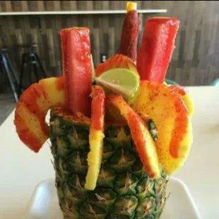 Pineapple filled with fruit and topped with chamoy. Piña loca