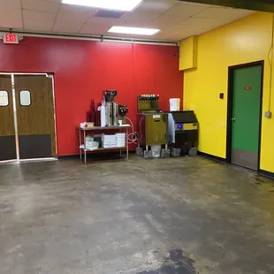 an empty room with a red wall and yellow walls