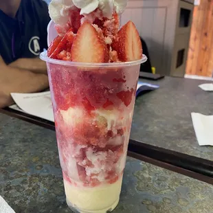 Strawberry snow cone with vanilla icecream. Also has condensed milk and whipped cream.
