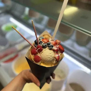 an ice cream sundae with strawberries, strawberries, and blueberries